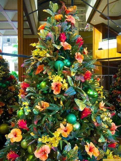 a christmas tree decorated with flowers and ornaments