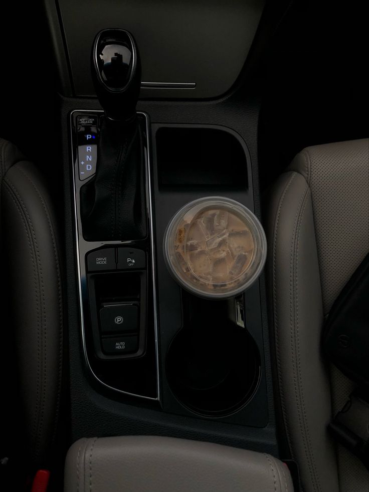 the interior of a car with an automatic cup holder