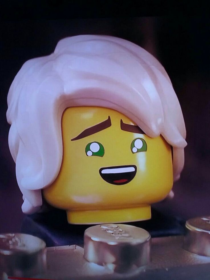 a lego head with white hair and green eyes