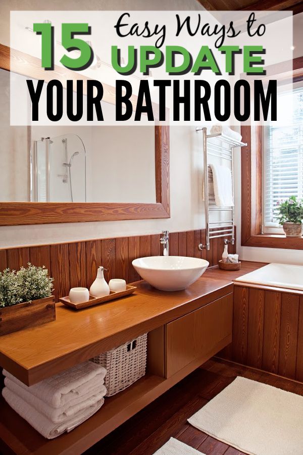 a bathroom with wooden cabinets and a white bowl on the counter next to a sink