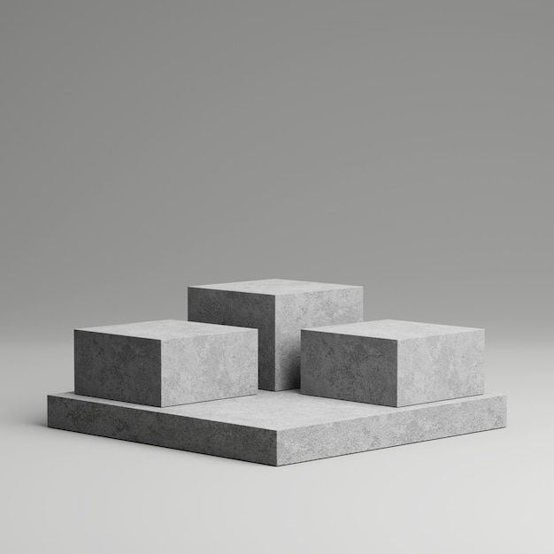 three concrete blocks sitting on top of each other in front of a gray wall and floor