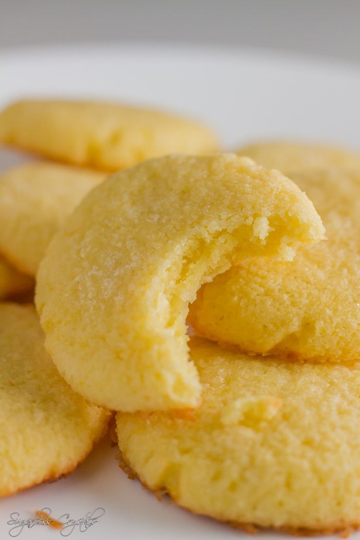 lemon sugar cookies on a white plate with text overlay that reads keto - low carb lemon sugar cookies