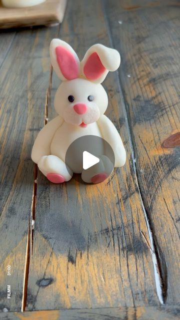 a small toy rabbit sitting on top of a wooden table