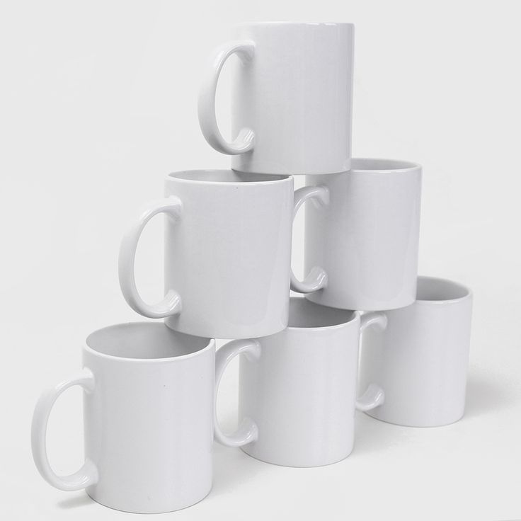 a stack of white coffee mugs sitting next to each other on a white surface