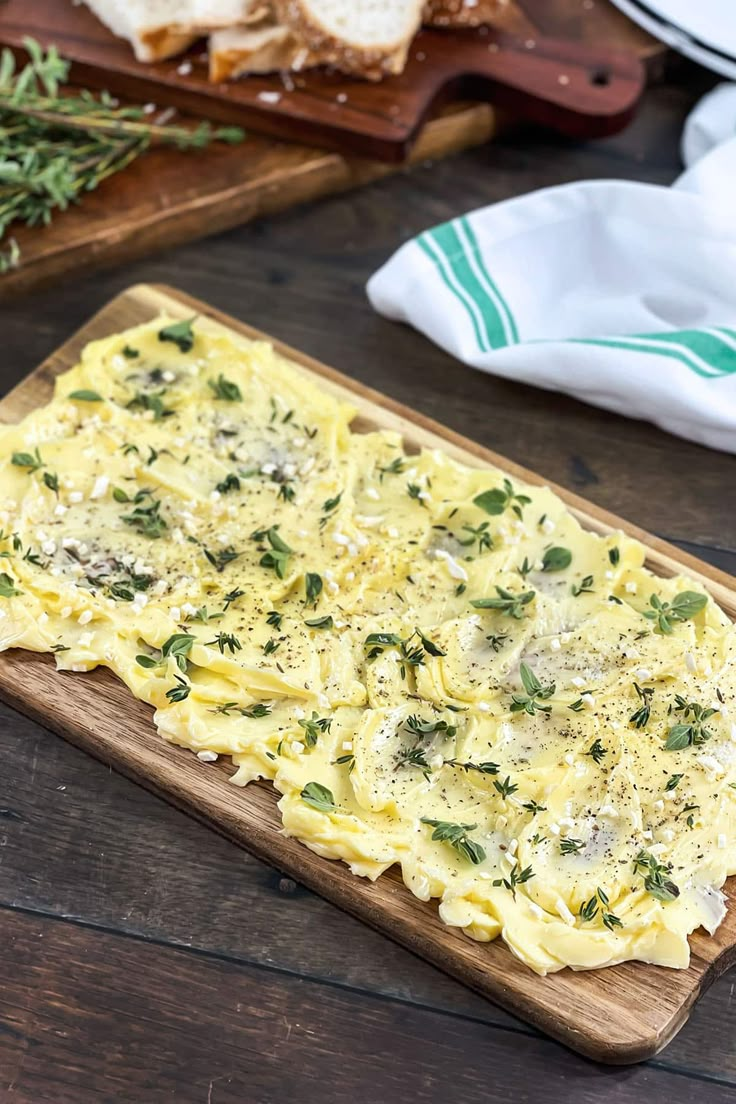 a wooden cutting board topped with pasta and cheese