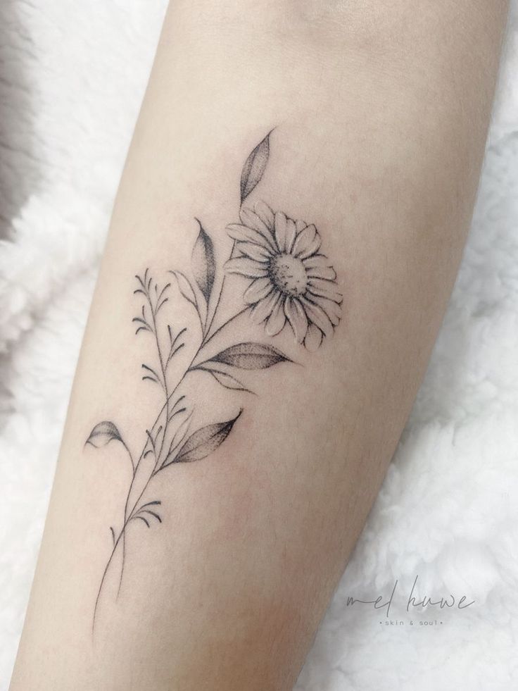 a black and white flower tattoo on the leg