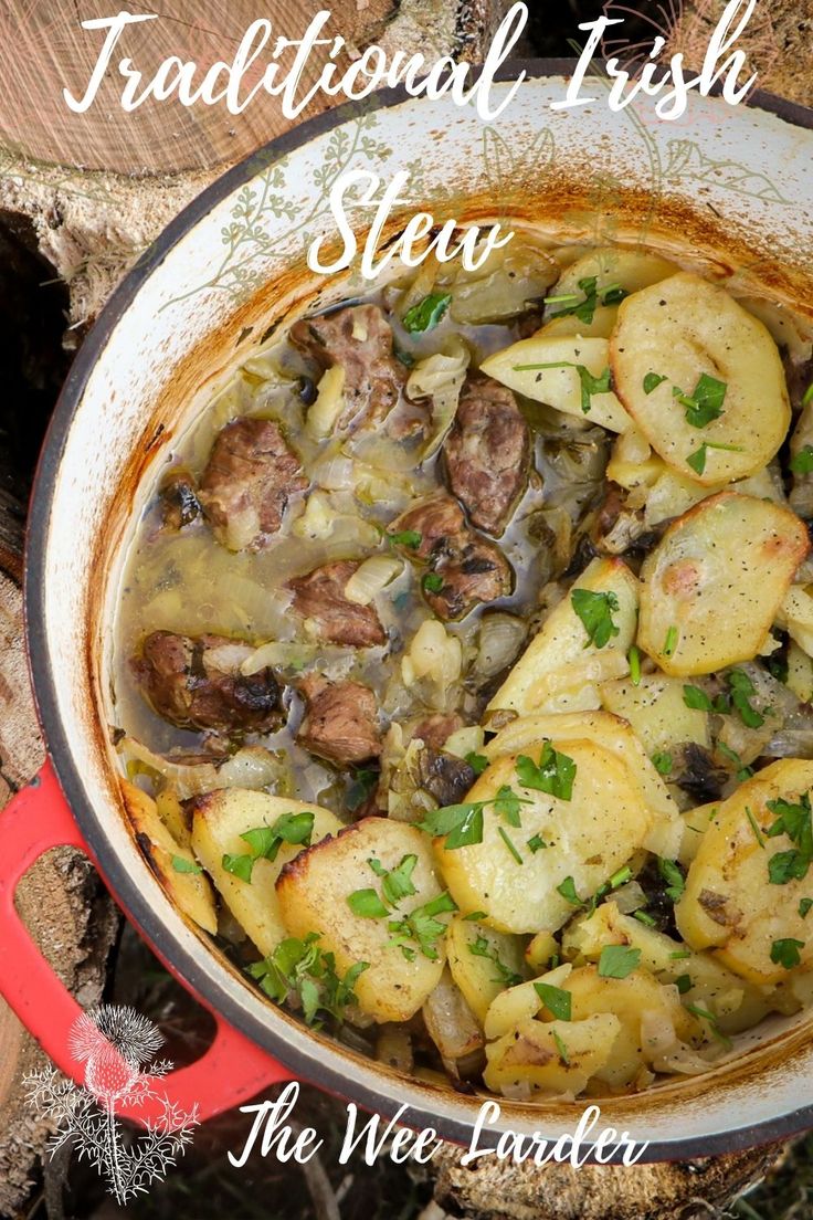 traditional irish stew with potatoes and meat in a red pot on top of the wood