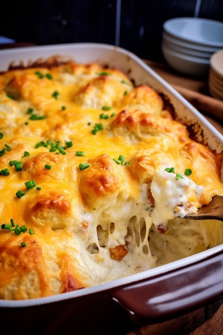 a casserole dish with cheese and green onions