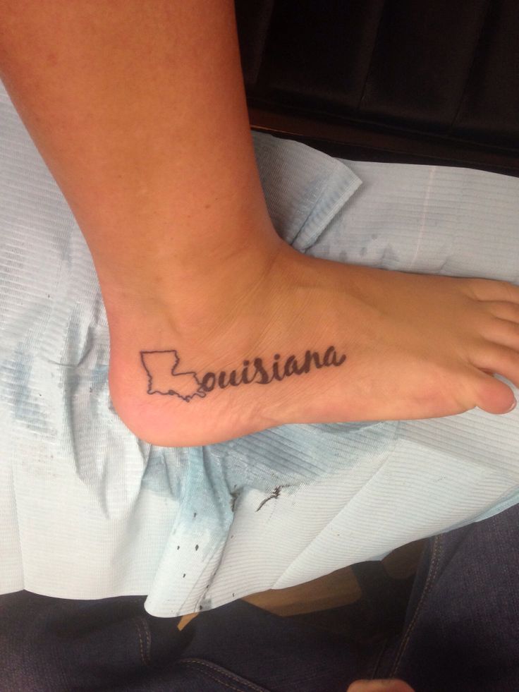 a person with a small tattoo on their foot that says, romana in cursive writing