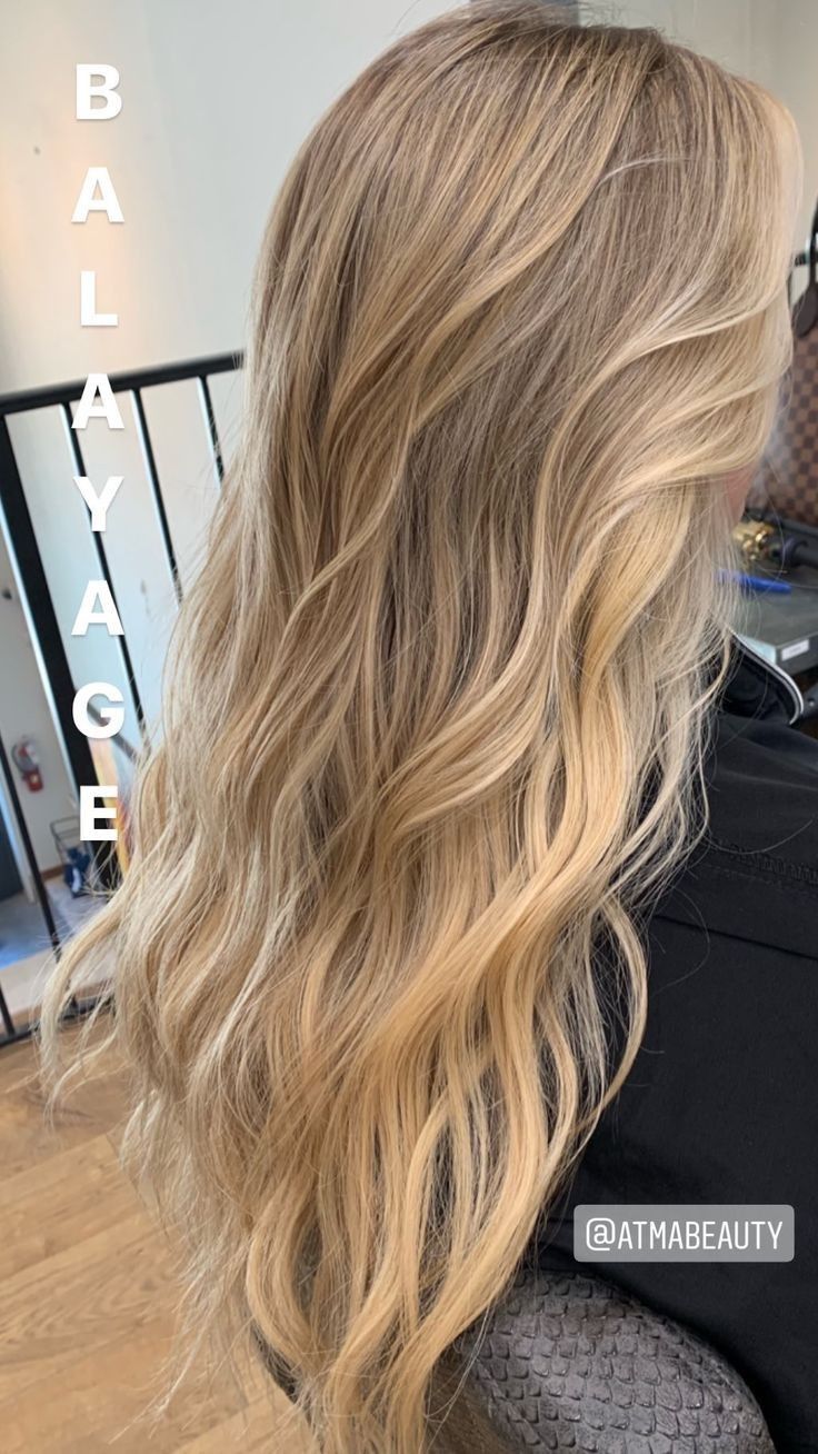 the back of a woman's head with long, blonde hair in front of her