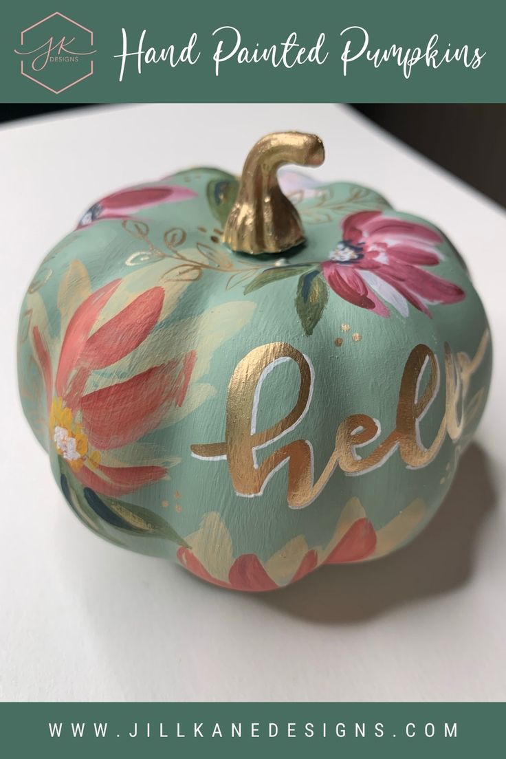 a painted pumpkin sitting on top of a table