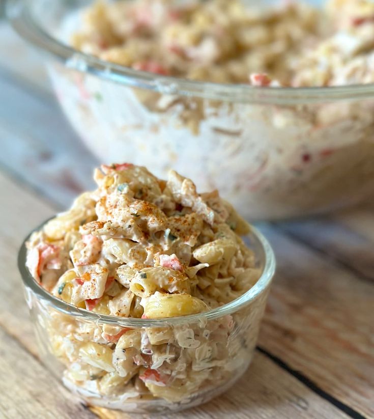 two bowls filled with food sitting on top of a wooden table