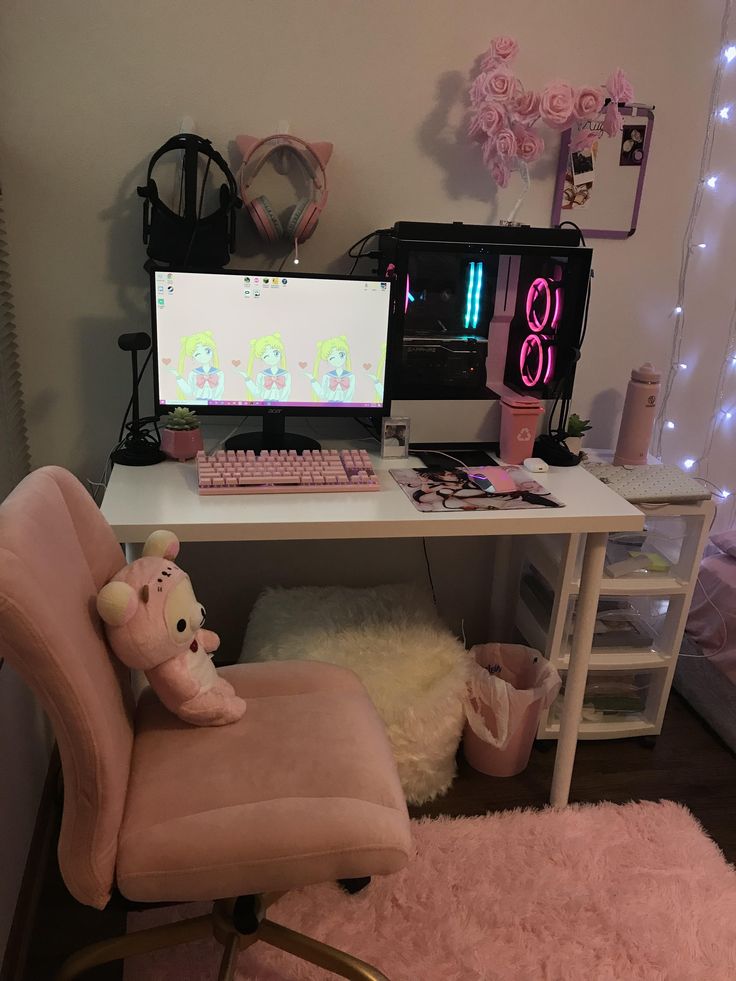 a pink chair sitting in front of a computer desk