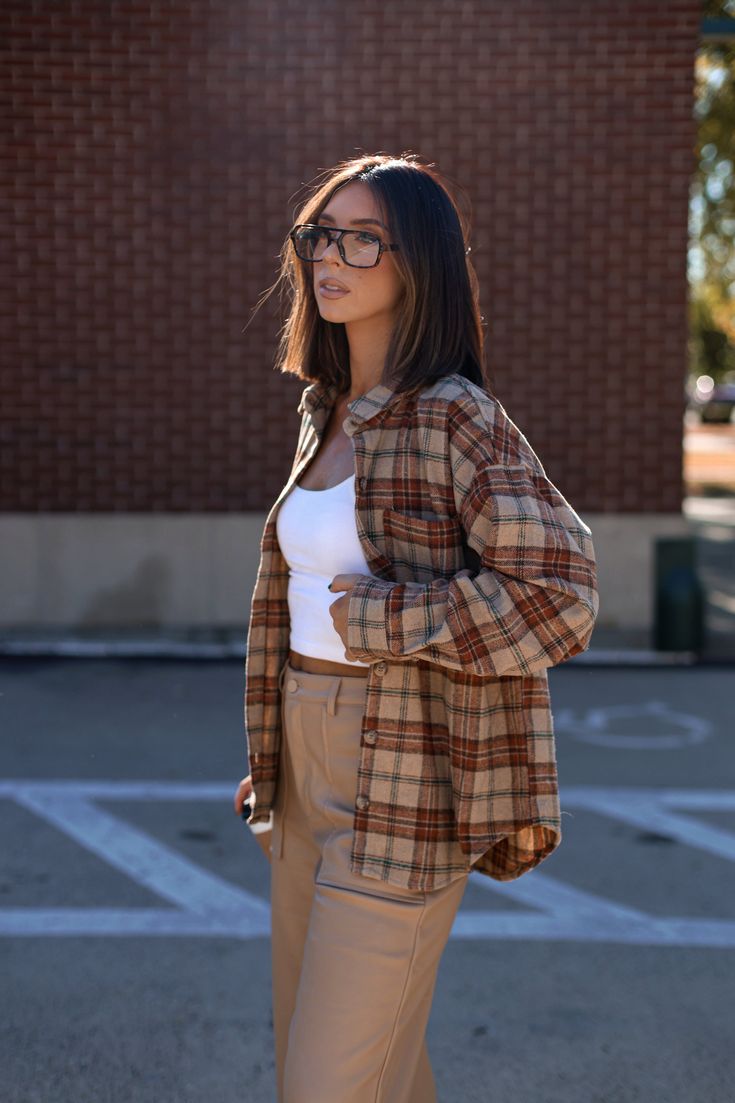 Feel cozy yet classic in this luxe plaid top featuring a collared neckline with button closures and pocket detail for that added touch of sophistication. The rounded hem offers a relaxed fit perfect for any Fall outings like shopping errands, brunch, and even bonfires. A must-have transition piece that is trendy and elevated, this Backroads Bonfire Plaid Top is an essential for any warm and cozy weekend. 90% Polyester 10% Wool Hand wash cold. Fall Flannel Shirt For Casual Gatherings, Flannel Shirt For Casual Gatherings In Fall, Fall Plaid Flannel Shirt For Workwear, Plaid Flannel Shirt For Work In Fall, Classic Flannel Shirt For Fall Casual Gatherings, Collared Flannel Shirt For Casual Fall Gatherings, Classic Tops For Day Out In Fall, Casual Flannel Shirt For Fall Day Out, Flannel Shacket For Workwear In Fall