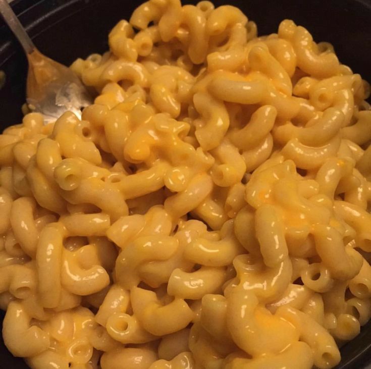 macaroni and cheese is being cooked in a skillet