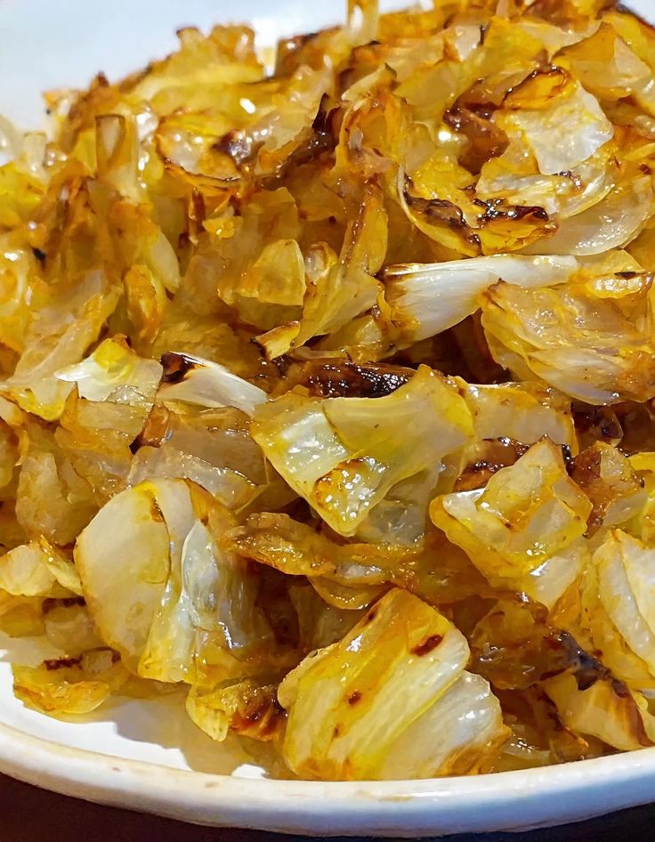 a white bowl filled with onions on top of a table