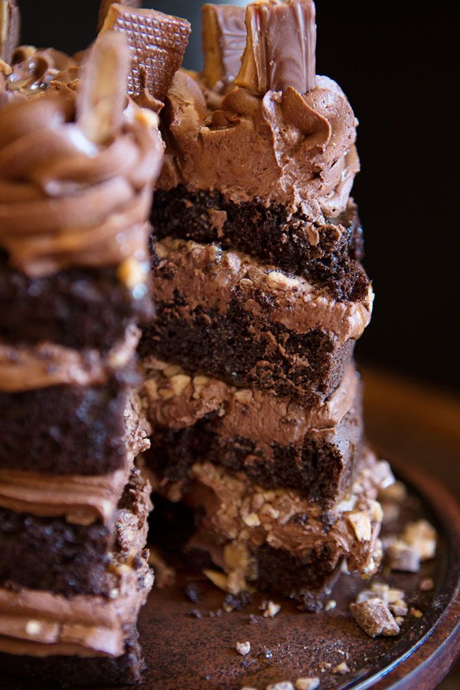 a chocolate cake with two pieces cut out and stacked on top of eachother