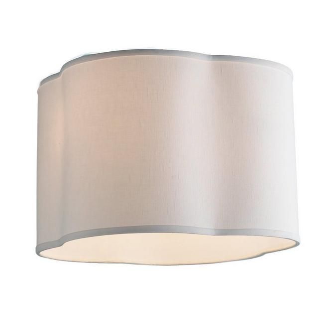 a light fixture with a white shade on the bottom and beige fabric covering over it