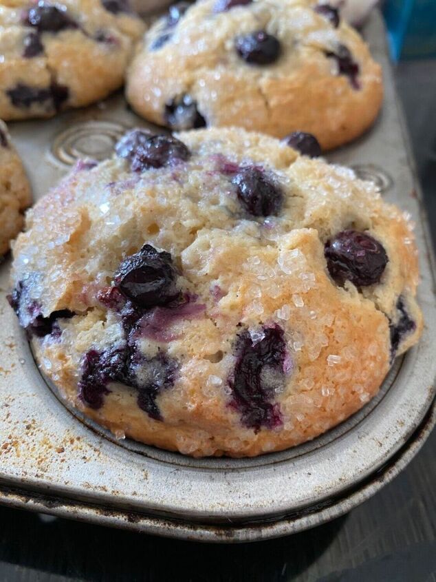 blueberry muffins sitting on top of a baking pan