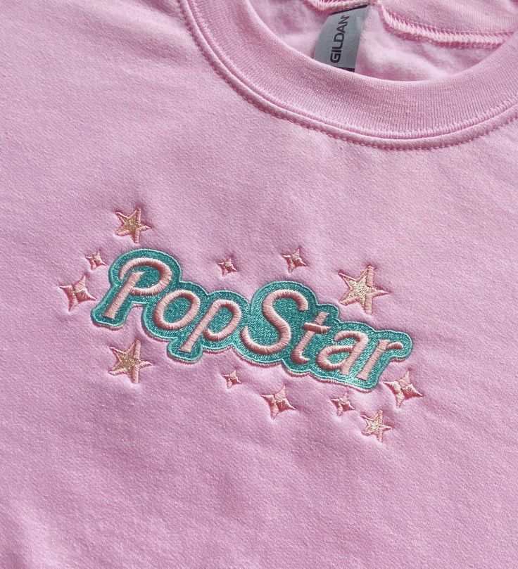 ✰ POPSTAR ✰ We all have an inner pop star in us, and now you can let the world know about your mega pop princess stardom with a cute sweatshirt <3  Inspired by 90s/2000s aesthetics, hyperpop girlies, and barbie/my scene dolls!! <3  Sweatshirts are unisex and run true to size! Heavy blend made up of 50% cotton, 50% polyester. Care Instructions: Machine wash warm, inside out, with like colors. Tumble dry medium. Do not bleach. Do not iron. May shrink over time in the wash! Trendy Custom Embroidery Tops For Streetwear, Pink Trendy Sweatshirt With Embroidered Logo, Star Sweatshirt Y2k, Trendy Pink Sweatshirt With Embroidered Logo, Pink Popstar Aesthetic, Pop Princess Aesthetic, 2000s Sweatshirt, Trendy Pink Sweatshirt With Embroidered Graphics, Pop Culture Cotton Sweatshirt With Screen Print