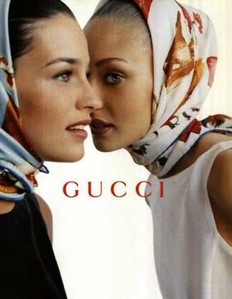 two women with headscarves on their heads are looking at each other and the words gucci in front of them