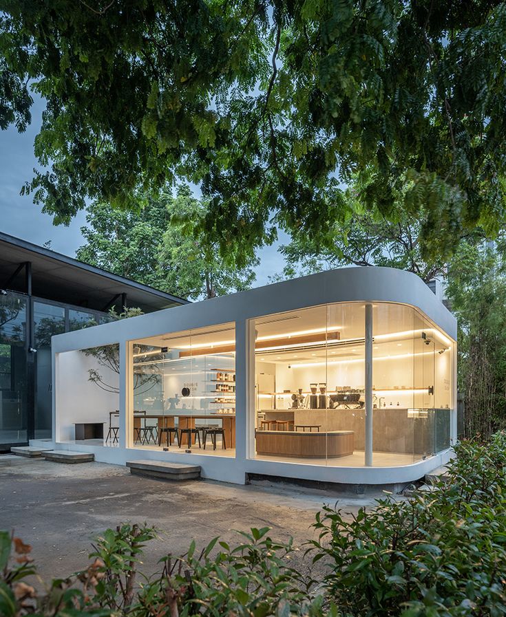 an unusual house with glass walls and lots of windows