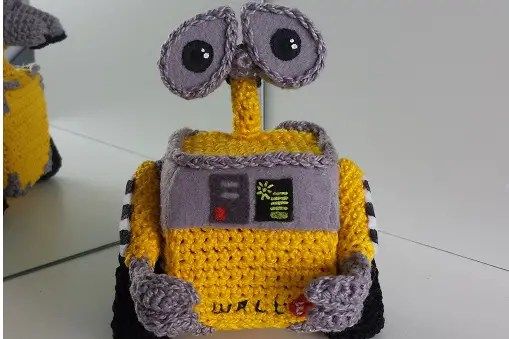 a crocheted yellow and gray robot ornament