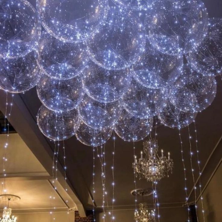 a chandelier with lights hanging from it's ceiling