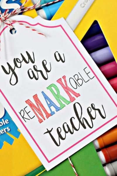 there is a sign that says you are a mark teacher with crayons around it