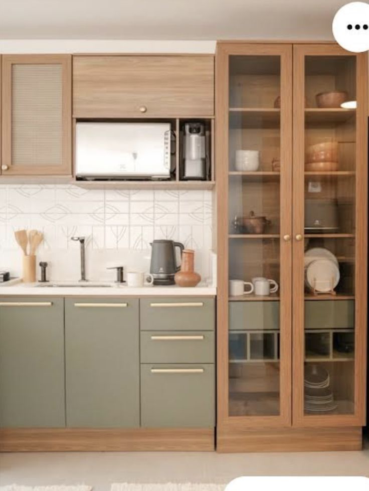 a kitchen filled with lots of wooden cabinets next to a counter top oven and microwave