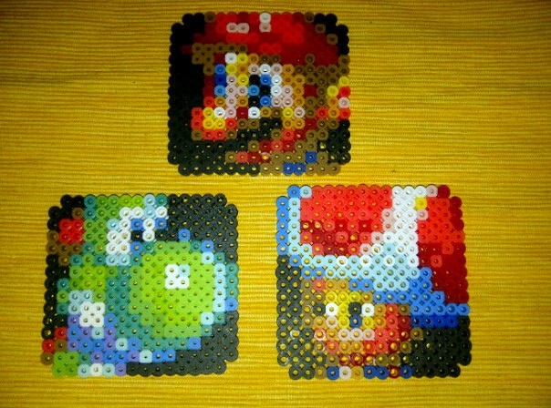 three lego coasters made to look like mario and luigi