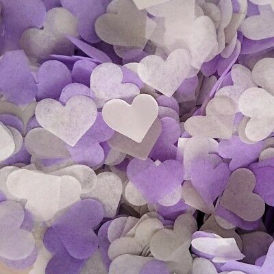 purple and white paper hearts are scattered together