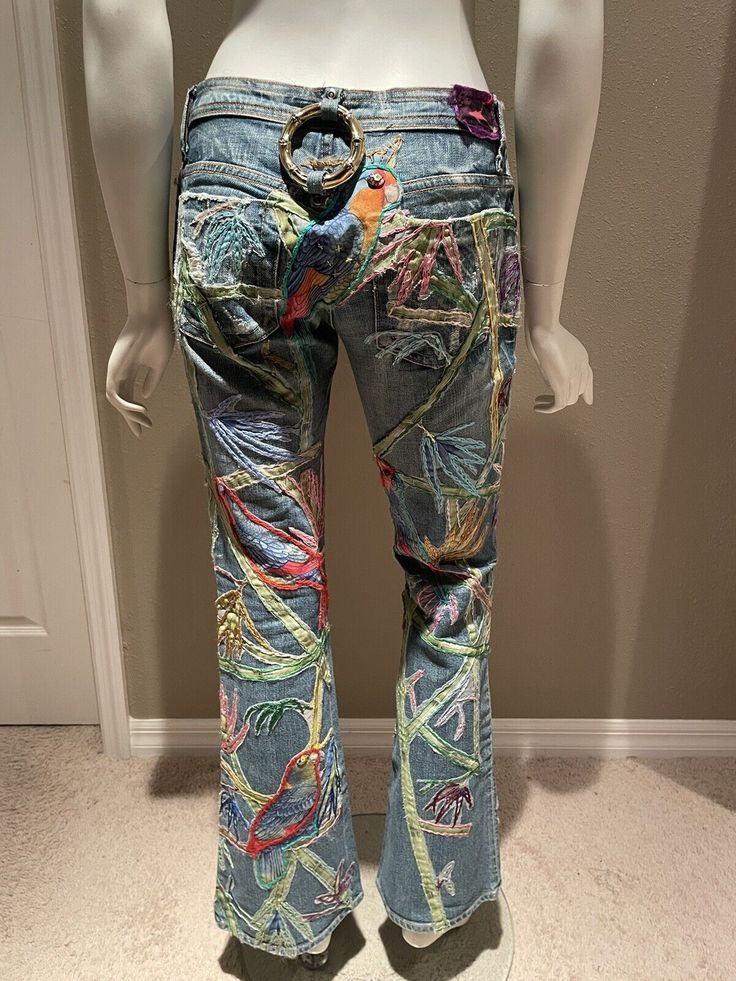 a mannequin wearing jeans with colorful designs on them