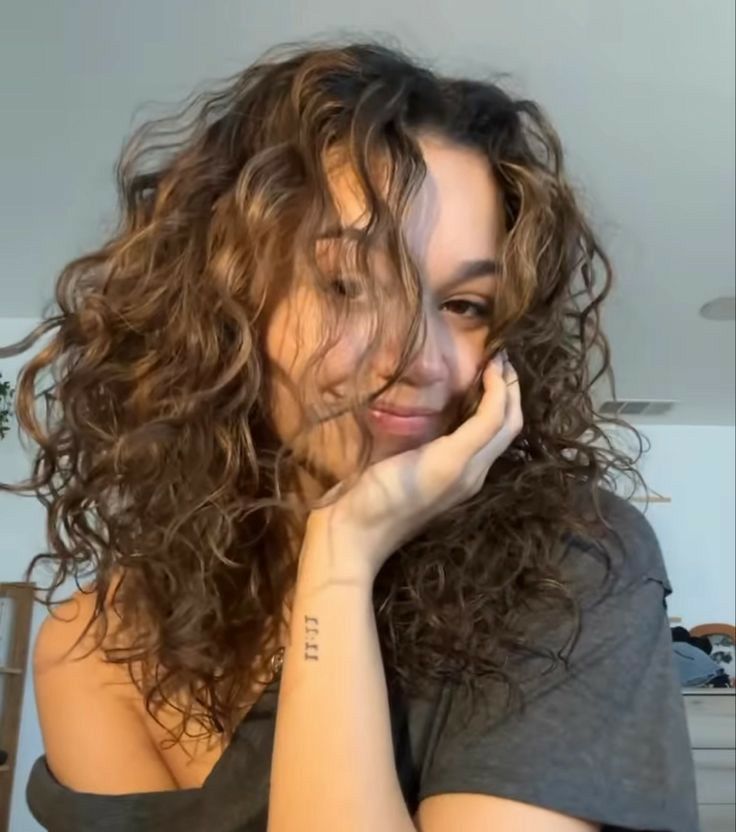 a close up of a person with curly hair