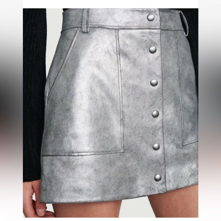 *Extremely Soft* Frame Silver Leather Button Front Skirt. Condition Is "New With Tags".. About This Item Details This Metallic Leather Skirt Is What I Call A Statement !!! - Fitted Waist - Button Front - Belt Loops - Dual Front And Back Pockets - Metallic Leather Construction - Approx. 15" Length (Size 25) - Imported Fiber Content Shell: 100% Lamb Leather Lining: 100% Acetate Care Dry Clean Trendy Fitted Mini Skirt With Snap Buttons, Fitted Mini Skirt With Snap Buttons, Button Closure Mini Skirt For Night Out, Trendy Skirt With Buttons For Night Out, Chic High-waist Skirt With Snap Buttons, Trendy Button Skirt For Night Out, Denim Mini Skirt With Snap Buttons, Trendy Party Skirt With Button Closure, Trendy Mini Skirt With Snap Buttons