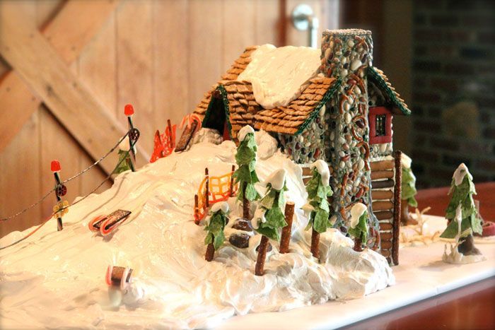 a gingerbread house made to look like it is in the snow