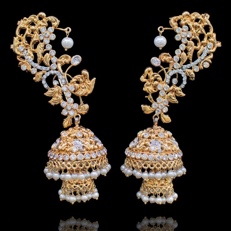 Make a lasting impact in these mesmerizing earrings! Beautiful cuff earrings studded with CZ stones and pearl moti. Approximate earrings length is 4.5". Gold-plated on high-quality brass as base metal. Made by order. Kindly allow 5-7 weeks for the delivery of this item. For custom or urgent requests, please contact support@alacouture.com. *Please Note: We use faux stones and beads in all of our jewelry. Gold Plated Ear Cuff For Wedding, Bollywood Style Jeweled Earrings For Reception, Gold Jeweled Bridal Earrings For Reception, Gold Plated Jeweled Bridal Earrings For Wedding, Silver Gold-plated Earrings With Stone Work, Gold Cubic Zirconia Earrings With Stone Work, Elegant Heavy Gold Plated Earrings, Gold Cubic Zirconia Earrings For Reception, Bollywood Style Gold Cubic Zirconia Earrings