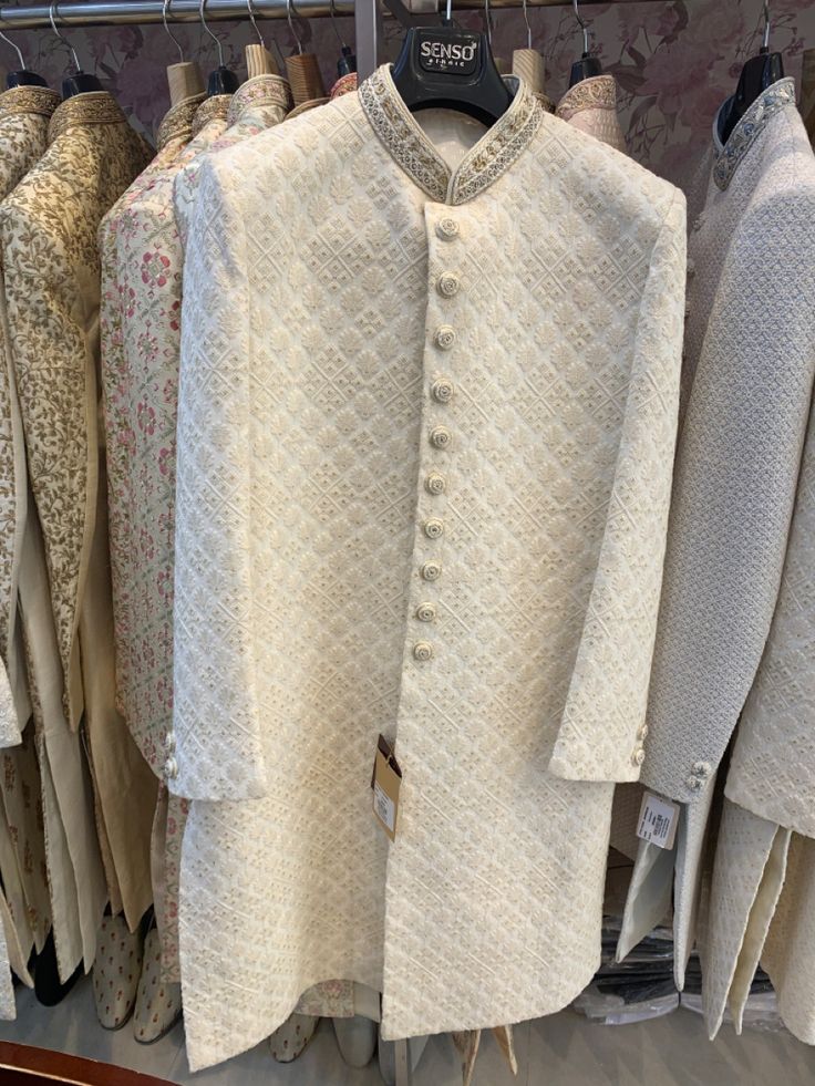 white clothing is on display in a store