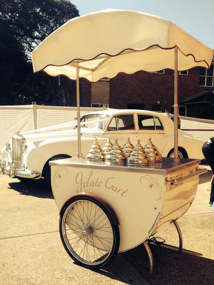 an old fashioned ice cream cart with bottles on it