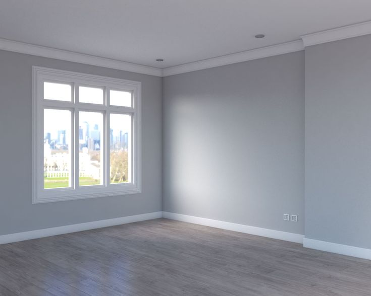 an empty room with white walls and wood floors