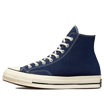 The Converse Chuck 70 Hi 'Navy' shoe is an essential for any fan of heritage style sneaker. This classic design offers a brilliant look that has been updated with modern details, such as a glossy egret midsole and star ankle patch. Built with premium recycled canvas and OrthoLite insoles to keep your feet comfortable, this retro shoe looks good while also providing optimal cushioning. With its archival color scheme, the Converse Chuck 70 Hi 'Navy' will elevate your style game no matter the occasion. (SNKR/Unisex/Classic/High Top) Classic Navy Lace-up Sneakers, Classic Navy Sneakers With Round Toe, Casual High-top Custom Sneakers With Cushioned Footbed, Converse Sneakers With Rubber Sole And White Sole, Classic Converse High-top Canvas Shoes, Classic Converse High-top Sneakers For Sports, Vintage High-top Sneakers With Cushioned Footbed, Navy High-top Skate Shoes With Rubber Sole, Converse Mid-top Sneakers With Rubber Sole