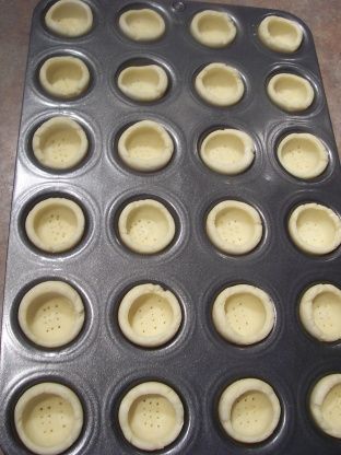 an uncooked muffin pan filled with cupcakes