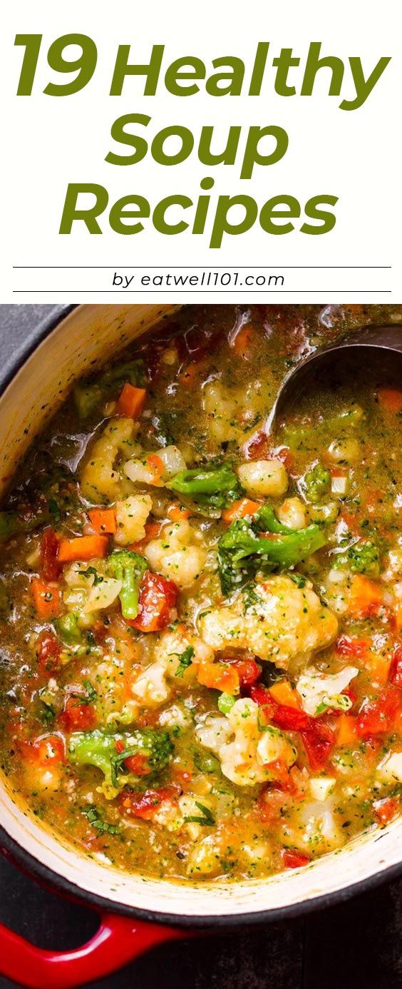 a red pot filled with soup and vegetables