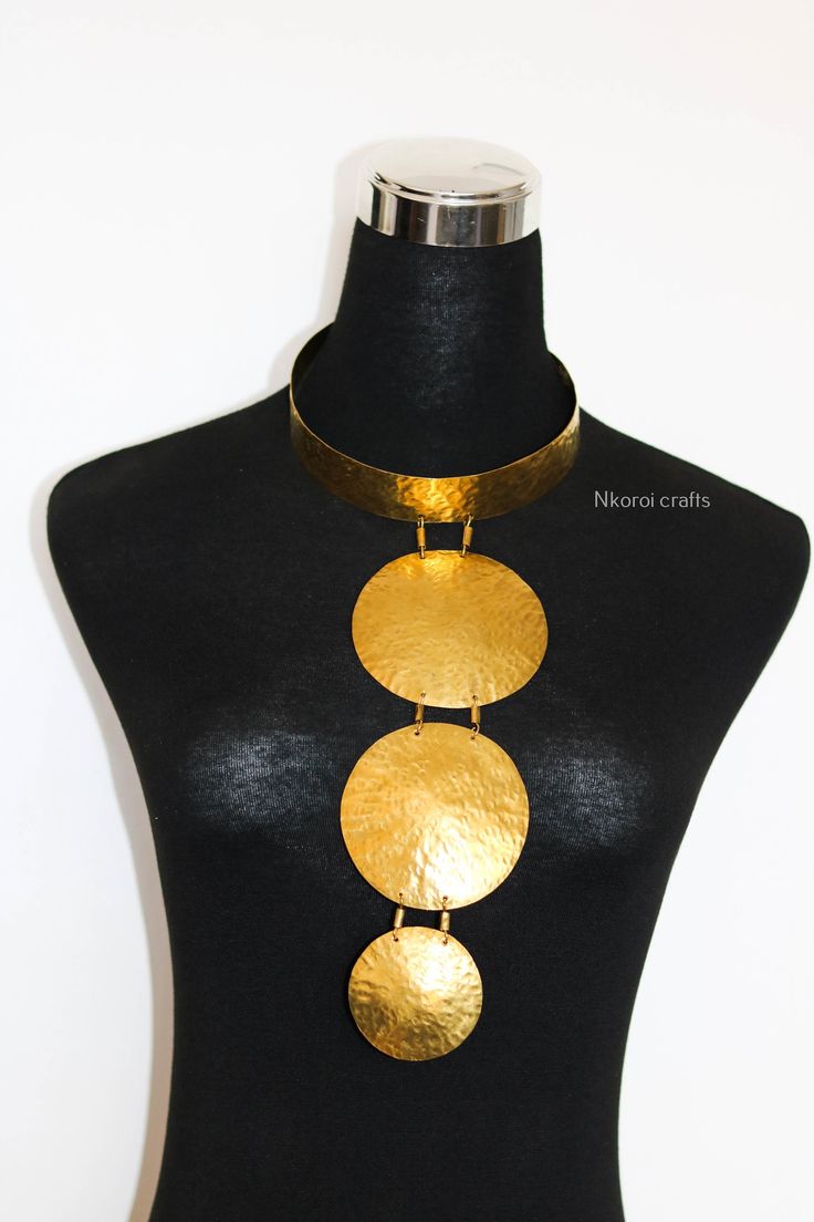 African Brass necklace, Brass jewelry, African jewelry for women, Tribal necklace, One size fits all, Christmas Gift for her, Moms gift The necklace is handcrafted using brass metal. Length: 14 inches Shipping fee is for the first item only, additional items ship for FREE. DHL Express shipping with 3-5 days delivery. To view our brass collection, click here: https://www.etsy.com/shop/NkoroiCrafts?ref=simple-shop-header-name&listing_id=1295061994&section_id=39639351 *Care instructions* Brass tarn Costume Jewelry Round Pendant For Party, Adjustable Choker With Unique Variations As Gift, Adjustable Round Pendant Necklace For Party, Adjustable Round Necklaces For Party, Costume Jewelry Metal Necklaces For Gifts, Adjustable Party Necklaces, Party Costume Jewelry Necklace With Round Pendant, Adjustable Pendant Necklace With Unique Design, Circular Metal Necklace For Gifts