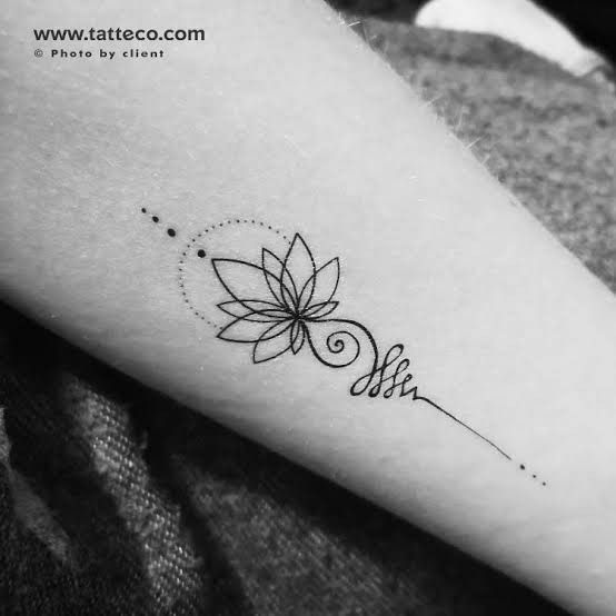 a woman's arm with a flower tattoo on the left side of her arm