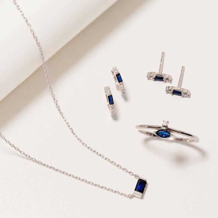 This necklace features a simulated blue sapphire baguette stone on a delicate, diamond-cut cable chain from our signature O Collection. Pair it with other necklaces from this collection. Our patented connectors let you easily link and layer necklaces in any order you desire. Pendant: Height 3mm x Width 7mm Adjustable chain: 15-17in (38-43cm) When layered, chain length is: 15-21in (38-53cm) Learn more Blue Sapphire Baguette Stone, Sterling Silver Spring clasp closure Hypoallergenic, lead and nick Blue Sterling Silver Cable Chain Jewelry, Blue Dainty Jewelry With Cable Chain, Blue Dainty Cable Chain Jewelry, Elegant Blue Jewelry With Cable Chain, Elegant Blue Cable Chain Jewelry, Everyday Sapphire Fine Jewelry, Fine Sapphire Jewelry For Everyday, Everyday Fine Sapphire Jewelry, Modern Sapphire Jewelry With Cubic Zirconia