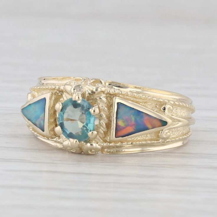 Gemstone Information: - Natural Alexandrite - Carats - 0.40ct Cut - Oval Brilliant Color - Green - Natural Opals - Size - 4 x 6.25 mm Cut - Triangle Color - Blue Green Multicolor Metal: 14k Yellow Gold Weight: 6.4 Grams Stamps: 14k Face Height: 9.3 mm Rise Above Finger: 5.4 mm Band / Shank Width: 3.3 mm This ring is a size 7, but it can be resized up 3 sizes for a $50 fee. Mens Custom Jewelry, Green Ring, Green Rings, Rise Above, Ring Pictures, Modern Ring, Opal Ring, Multi Stone Ring, Natural Opal