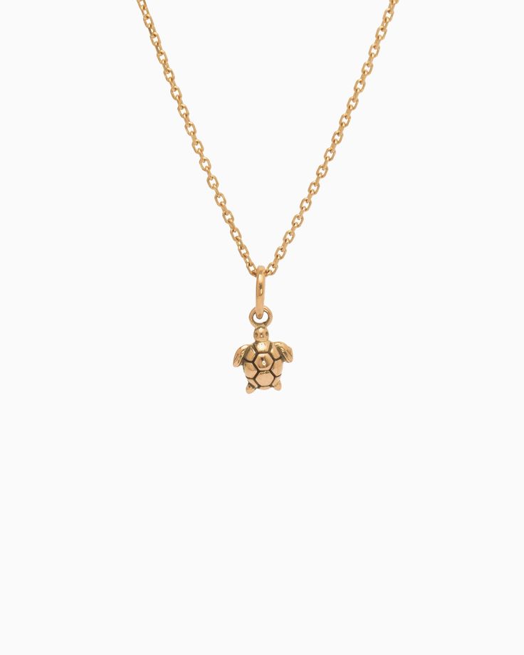 The Turtle Charm is handcrafted in 14K solid gold and features a detailed design inspired by sea turtles, celebrated as iconic symbols of the Caribbean. Playful yet sophisticated, this charm complements any look. Pair with your favorite hook bracelet or dainty chain, sold separately. Metal: 14K solid gold Dimensions: 9.5mm x 6mm x 2mm Style #: GC203S Adjustable Yellow Gold Jewelry With Logo Charm, Elegant Yellow Gold Turtle Jewelry, Hook Bracelet, Turtle Charm, Sea Turtle, Solid Gold, Gold