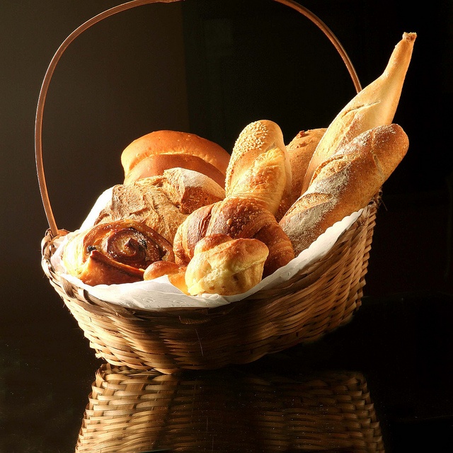 a basket filled with lots of different types of bread