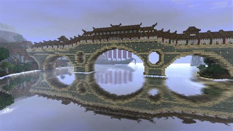 the reflection of an old bridge in water